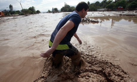 A man crosses a road amid the flooding in Copiapo.