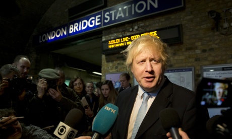 Mayor of London Boris Johnson with the busking band The Tailormade at London Bridge Station.