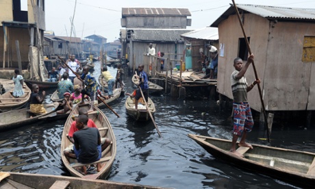 People navigate through the waterways of the Makoko slum in Lagos