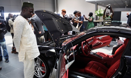A man looks at a car at the Porsche dealership in Lagos.