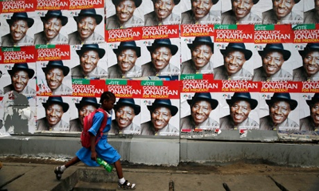 A schoolgirl walks past campaign posters in support of President Goodluck Jonathan in Lagos.