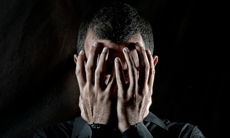 Depressed man head in hands