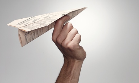 Hand holding a paper plane