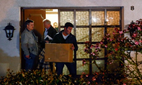 German police officers carrying items out of the home of Andreas Lubitz's parents