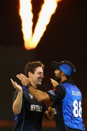 Matt Henry celebrates with team-mate Grant Elliott after dismissing David Warner.