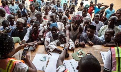 People wait to vote at a polling station in Abuja 