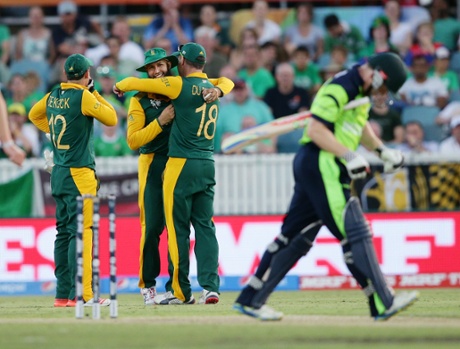 Hashim Amla is congratulated by teammates Quinton De Kock and Francois Du Plessis after taking a catch to dismiss Ireland's Niall O'Brien.