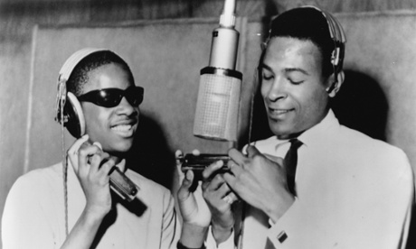 Marvin Gaye (with Stevie Wonder, left) around a microphone at the Motown recording studio in Detroit in 1965.