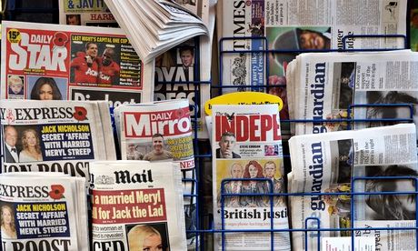 newspapers on a rack at a newsagent in London