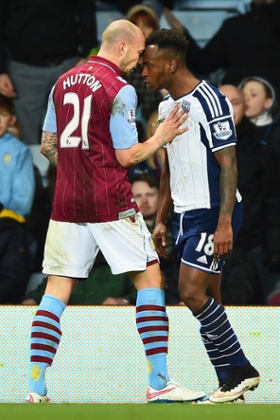 Alan Hutton of Aston Villa goes head to head with Saido Berahino of West Brom.