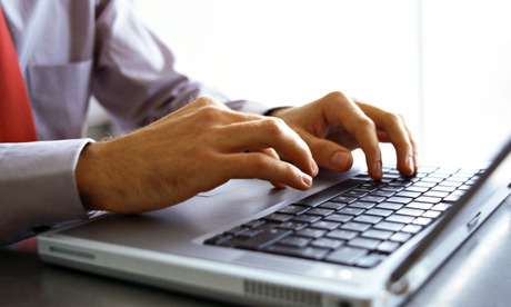 Man's hands on keyboard of laptop computer