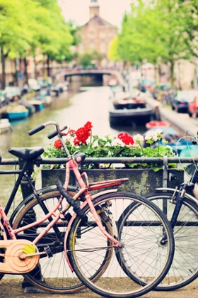 Bike on bridge over canal in Amsterdam