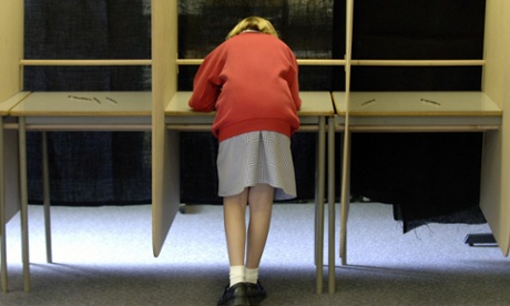 School pupil voting at a mock polling station
