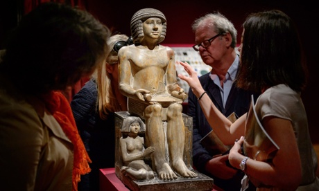 Members of the public and gallery staff examine the statue of Sekhemka at Christie’s auction house in central London before its sale in June 2014.