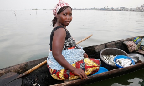 fish seller on boat, Cotonou, Benin