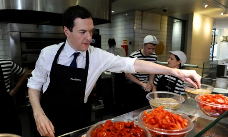 Chancellor George Osborne reaches for a pinch of pepper as he prepares a pizza during a visit to a Pizza Express in Hove.