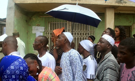 People wait to vote at an election centre in Lagos