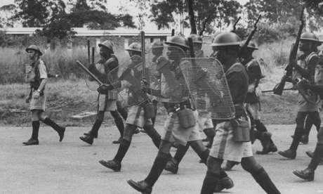 British colonial forces charge at a group of rioters in former Nyasaland in 1959.