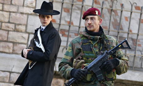 A Belgian paratrooper keeps guard outside a Jewish school in central city of Antwerp