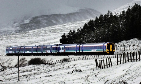 A ScotRail train cuts its way through heavy snow near Avimore, Scotland