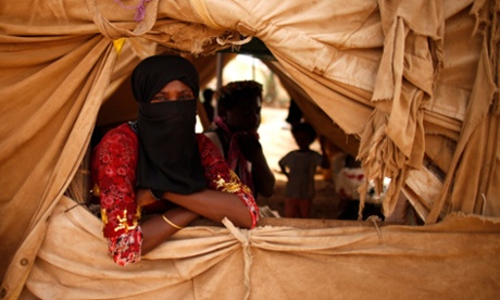 A woman looks from a window of her family's tent in al-Mazraq in 2013.