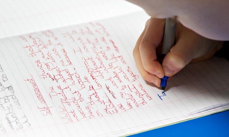 UK Primary school child writes in an exercise book