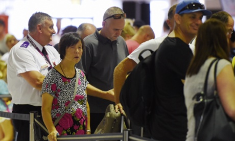 Helen Chan, the mother of Bali Nine's Andrew Chan, waits in-line to check in at Sydney International Airport