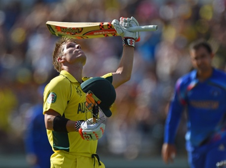 David Warner raises his bat after reaching his 100.