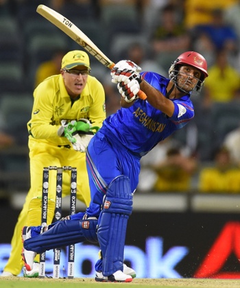 Najib Zadran, watched by Brad Haddin as he hits a six.