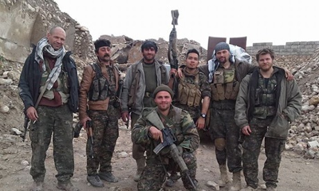 Kurdish fighters and foreign volunteers fighting against Isis, with Konstandinos Erik Scurfield in the foreground.