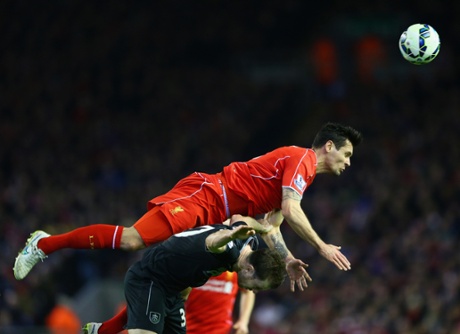 Liverpool's Dejan Lovren climbs to win the ball.