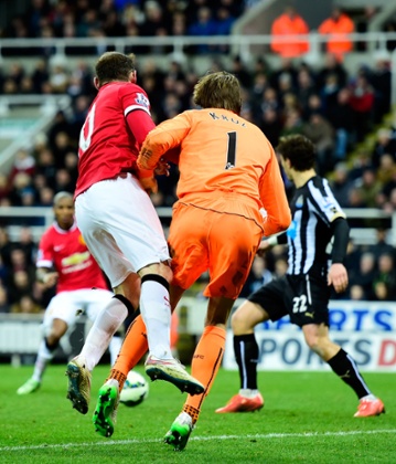 Wayne Rooney clatters into Tim Krul as the Newcastle keeper's pass goes straight to Ashley Young ...