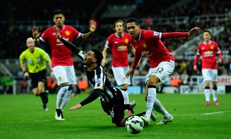 Manchester United player Chris Smalling, right, is lucky that the ref's view of his challenge on Emmanuel Riviere might well be obscured by his team-mates.