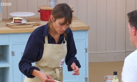 Alexa Chung wearing an apron on Bake Off -