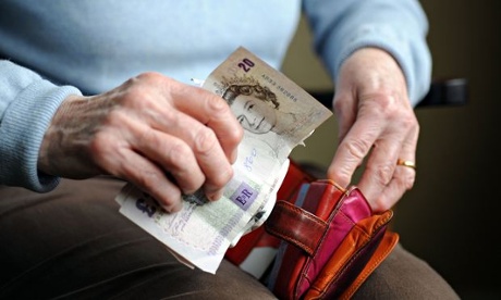 Elderly woman counting out money from her purse