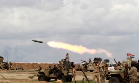 Shi'ite fighters launch a rocket towards Islamic State militants during heavy fighting in Salahuddin province.
