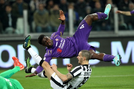 Micah Richards falls over Juventus' defender Leonardo Bonucci.