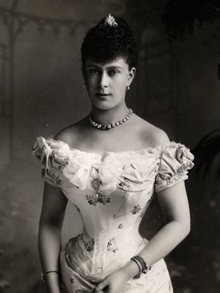 A black and white photograph of Queen Mary on her wedding day to George V