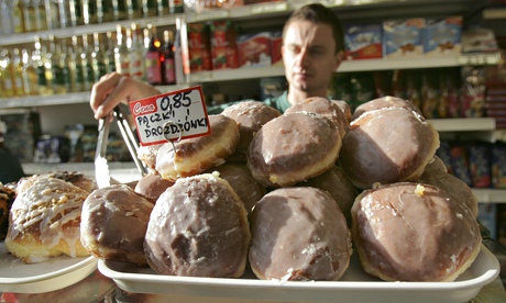 A shopkeeper in London selling traditional Polish buns.