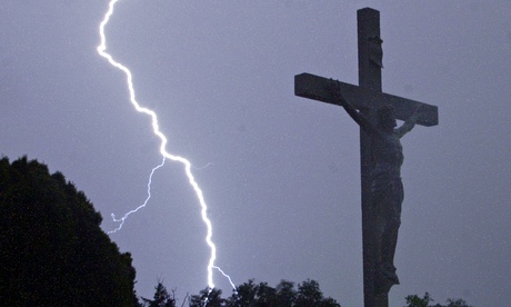 Lightning strikes behind a crucifix