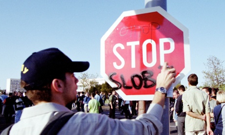 An Otpor member vandalises a traffic sign during protest demonstrations in Belgrade, Yugoslavia in 2000.