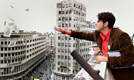 A Belgrade student throws leaflets from a rooftop  as part of the 2000 protests against Slobodan Mil