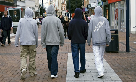 Four youths walking along a high street