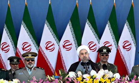 Iran's President Hassan Rouhani (second right) speaks in front of the mausoleum of the late rAyatoll