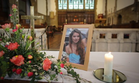 A candle burns besides a photograph of Becky Watts at St Ambrose Church in Bristol.