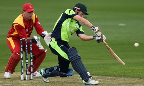 Zimbabwe wicket-keeper Brendan Taylor looks on as Ireland batsman Ed Joyce plays a shot during the 2015 Cricket World Cup Pool B match in Hobart.