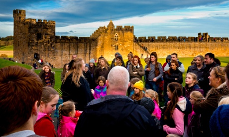 Tour guide and group of visitors on Harry Potter theme tour of Alnwick Castle.