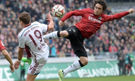 Bayern Munich's Mario Götze and Hannover's Manuel Schmiedebach fight for the ball during their Bundesliga game.