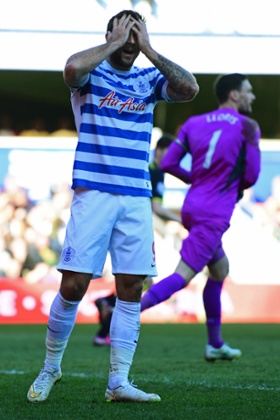 The QPR striker can't believe his shot hit the woodwork rather than the back of the net.