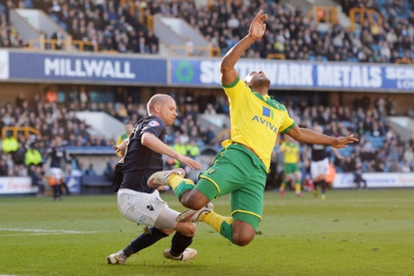 Millwall's Alan Dunne fouls Norwich's Cameron Jerome and the ref points to the penalty spot.